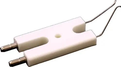 Elektrodenblock aus weißem Material mit zwei Metallanschlüssen, verwendet in Verbindung mit Wolf Cuenod-Gelbbrennern.